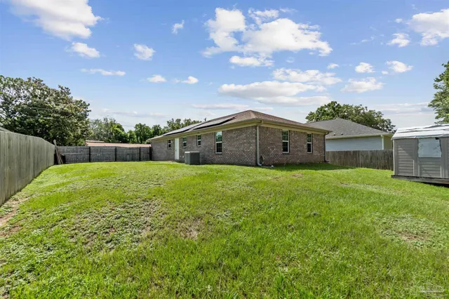 a view of a house with a backyard