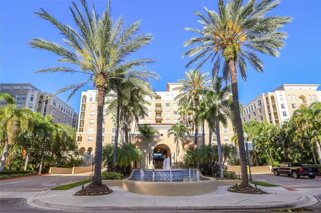 a view of a palm trees front of the house
