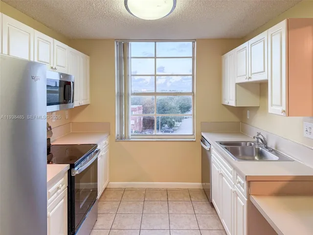 a kitchen with a sink a refrigerator and a sink