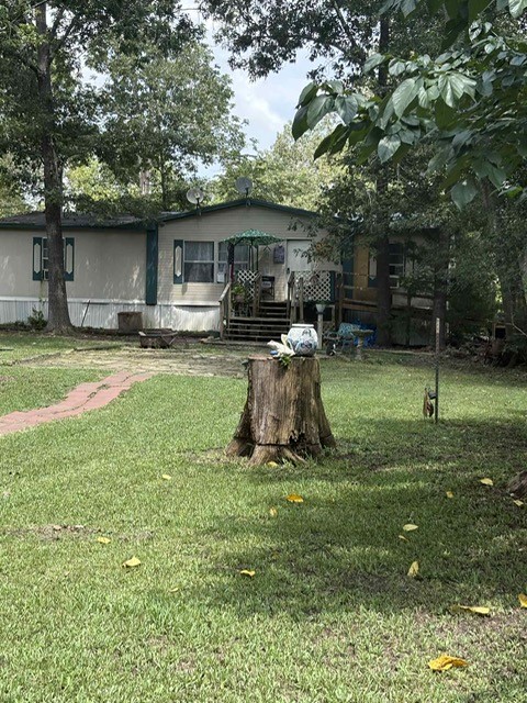 320 Oak Tree Drive Point Blank, TX 77364 - Photo 12 of 22 a view of a backyard with a car parked in it