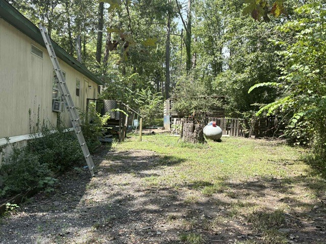 320 Oak Tree Drive Point Blank, TX 77364 - Photo 22 of 22 a backyard of a house with fountain table and chairs
