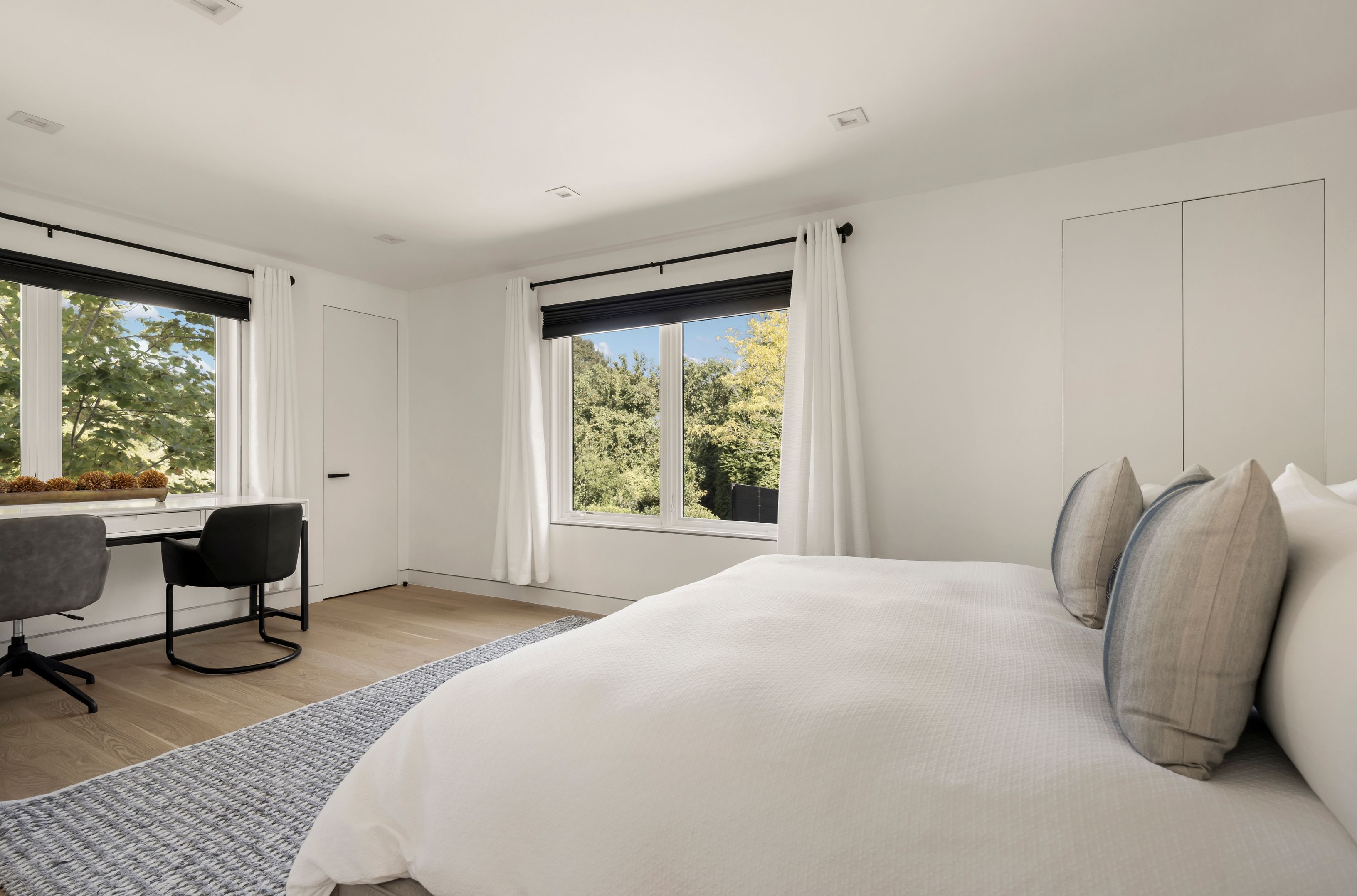 1076 Ocean Road Bridgehampton, NY 11932 - Photo 21 of 38 a bedroom with a bed and a chair