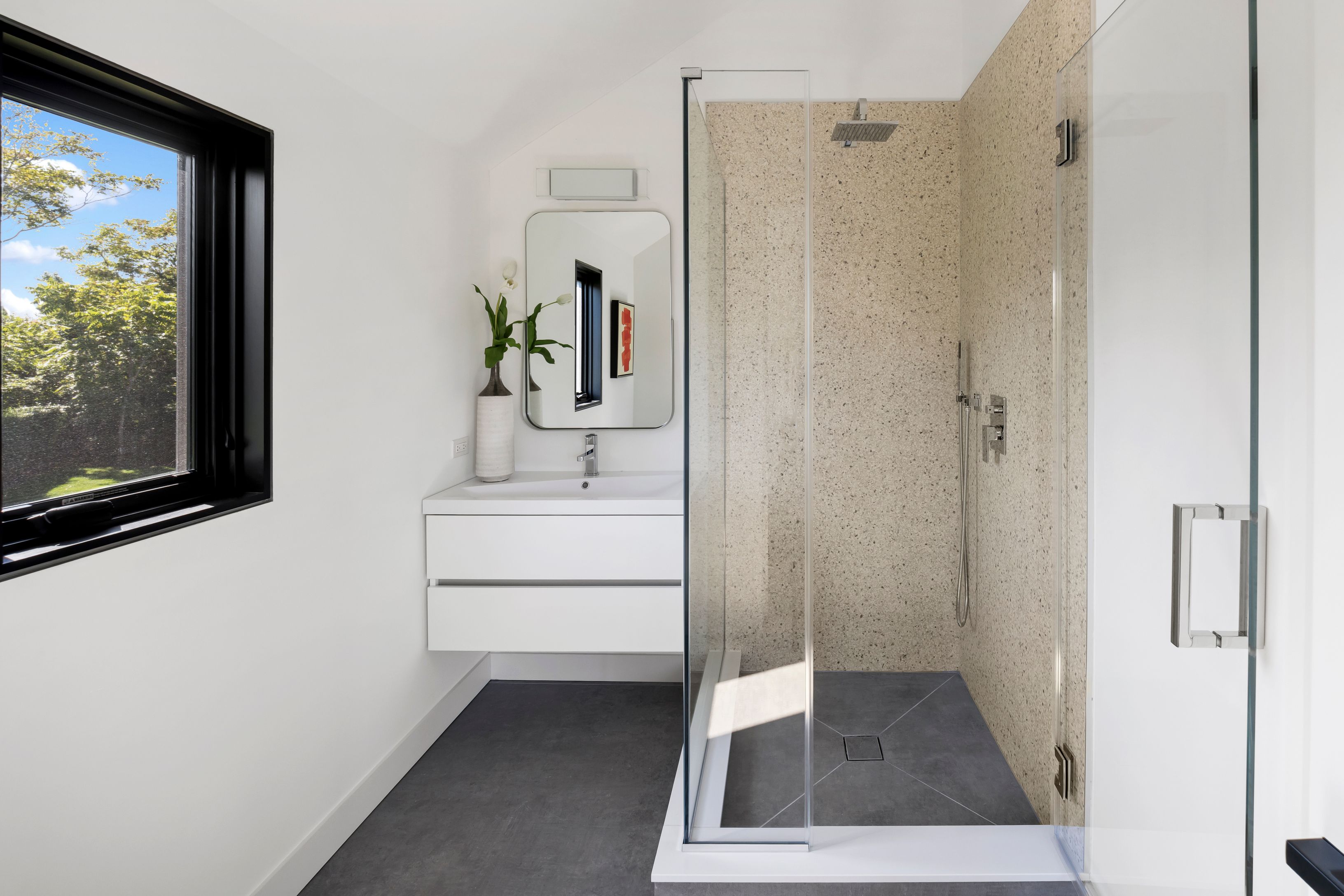 1076 Ocean Road Bridgehampton, NY 11932 - Photo 22 of 38 a bathroom with a sink a mirror and a shower