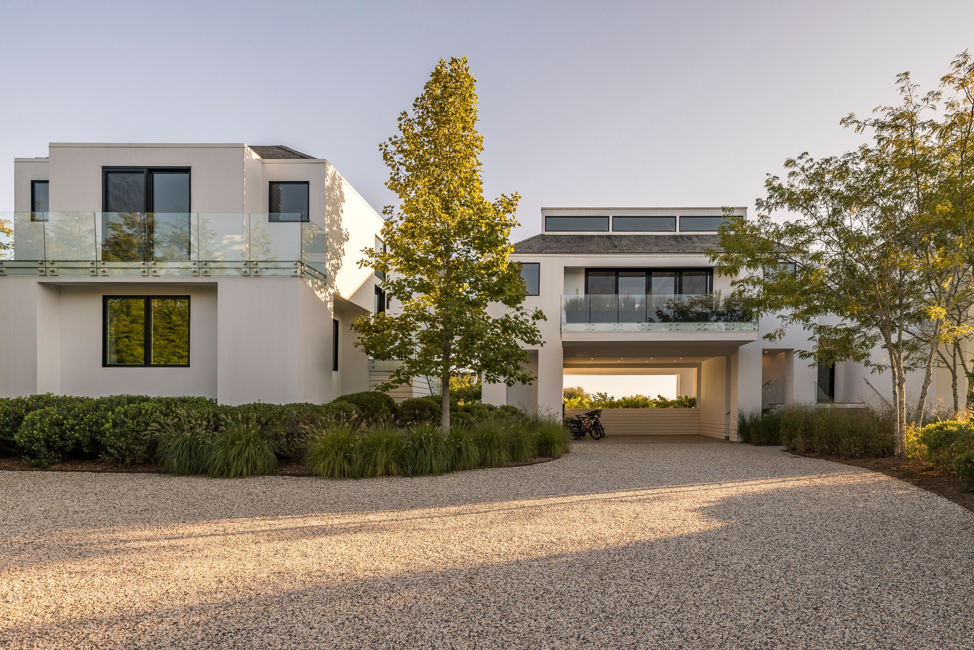 1076 Ocean Road Bridgehampton, NY 11932 - Photo 33 of 38 a front view of a house with a yard and garage