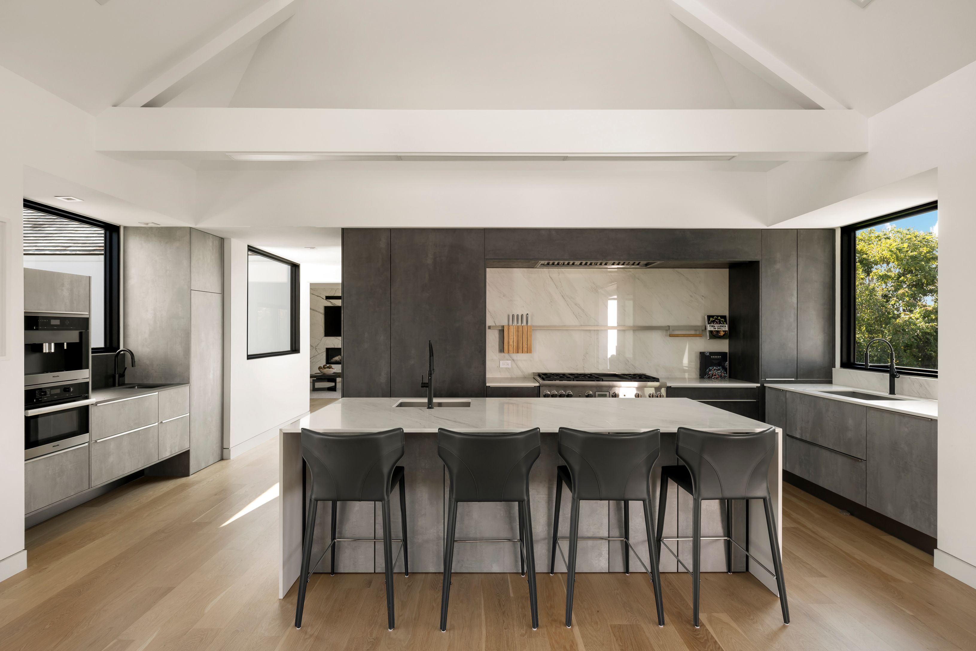 1076 Ocean Road Bridgehampton, NY 11932 - Photo 10 of 38 a kitchen with stainless steel appliances kitchen island granite countertop a table and chairs in it