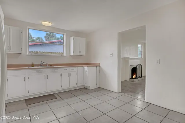 an empty room with chandelier fan