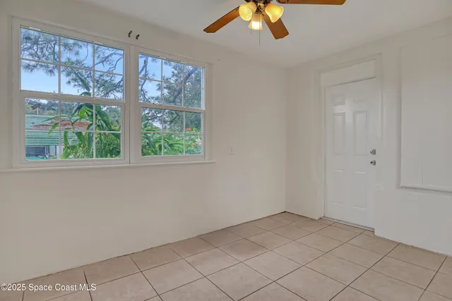 a view of room with window and ceiling fan