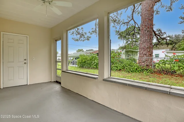 a view of a kitchen with a sink and a refrigerator