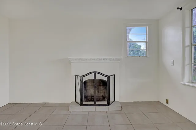 a kitchen with white cabinets and window