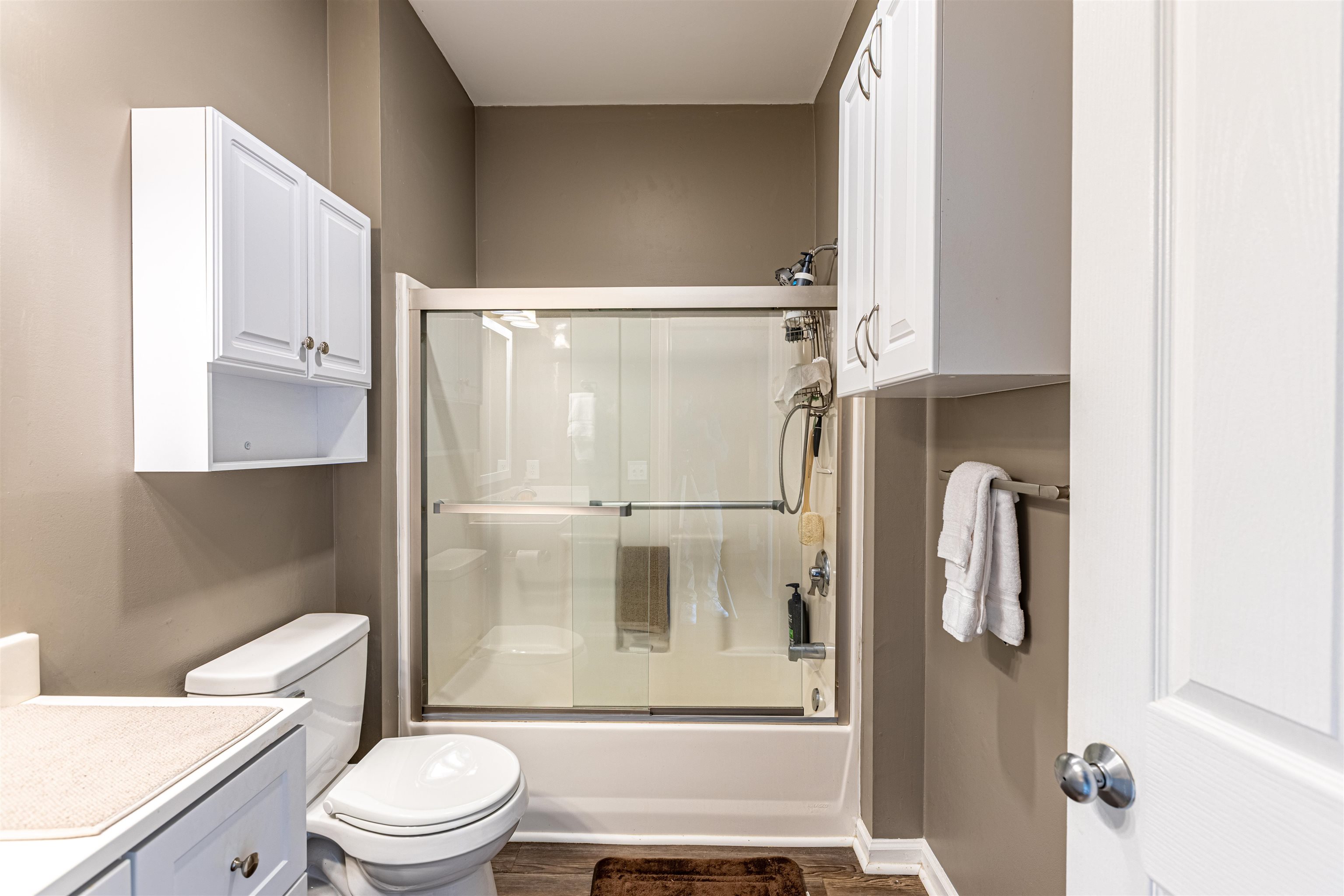 4585 Girvan Drive, Unit D Myrtle Beach, SC 29579 - Photo 13 of 32 Full bath with vanity, shower / bath combination with glass door, and dark wood-style floors