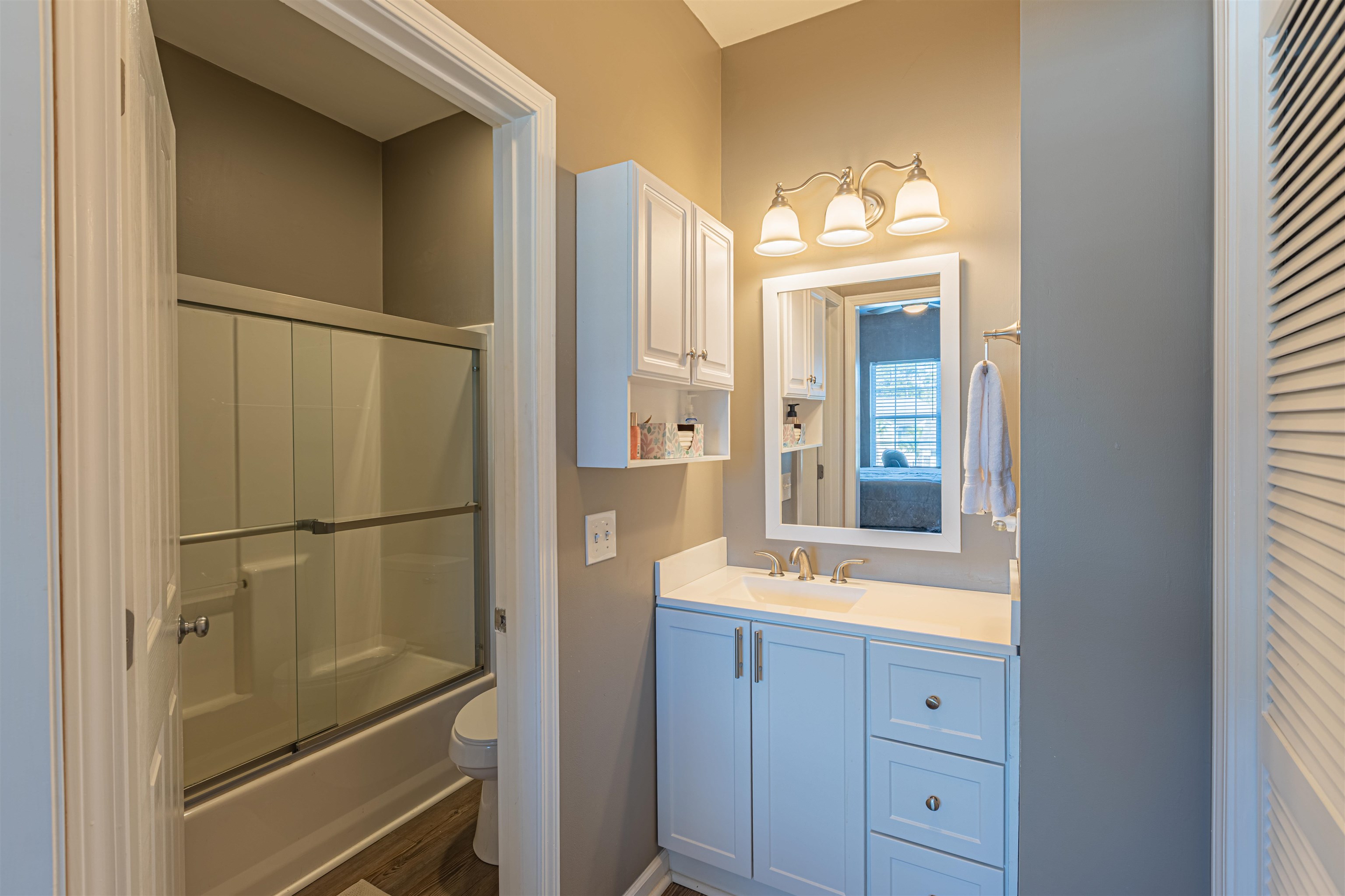 4585 Girvan Drive, Unit D Myrtle Beach, SC 29579 - Photo 17 of 32 Full bathroom featuring vanity, shower / bath combination with glass door, and a closet