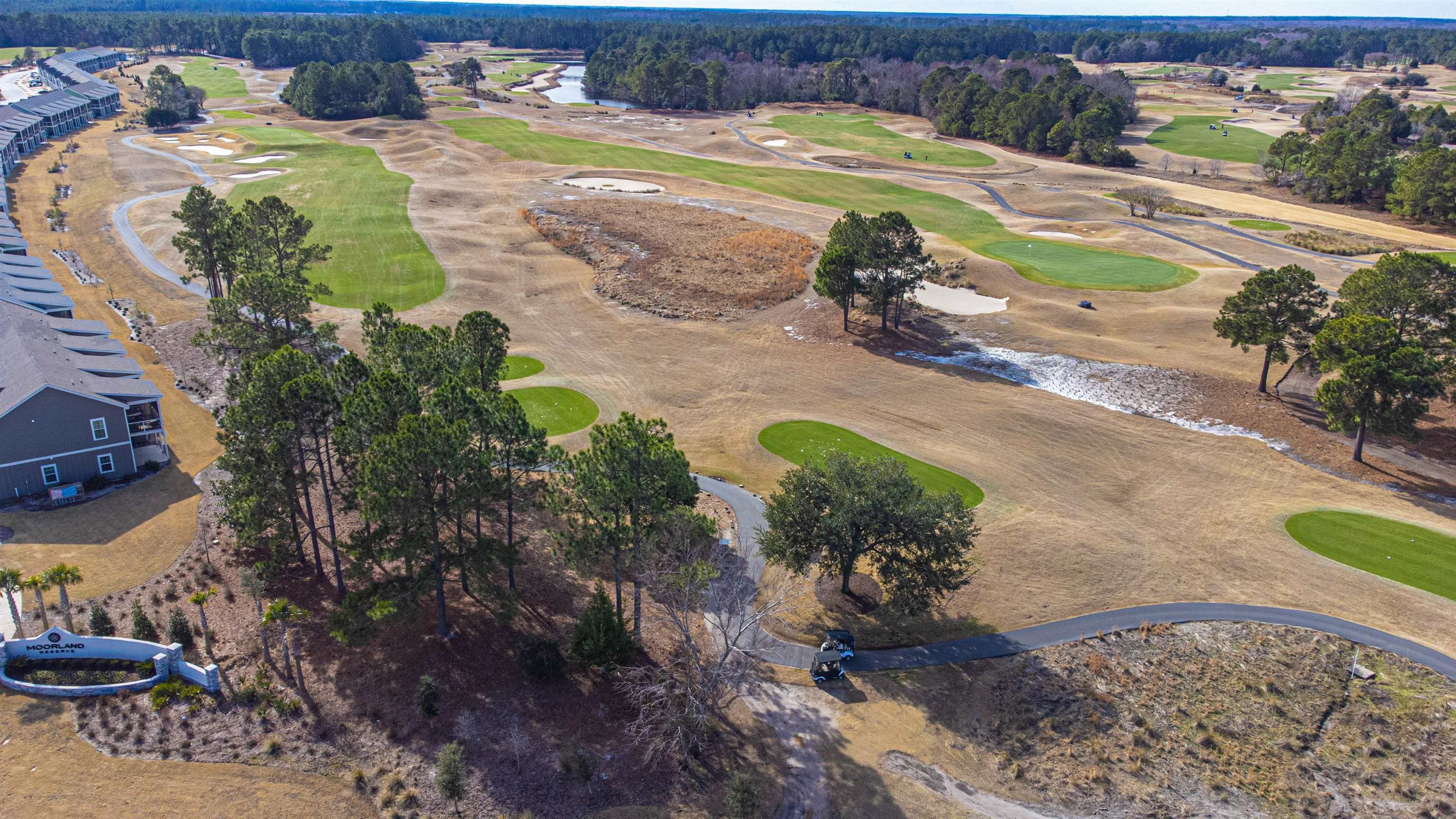 4585 Girvan Drive, Unit D Myrtle Beach, SC 29579 - Photo 28 of 32 Aerial view of a golf course and a large body of water