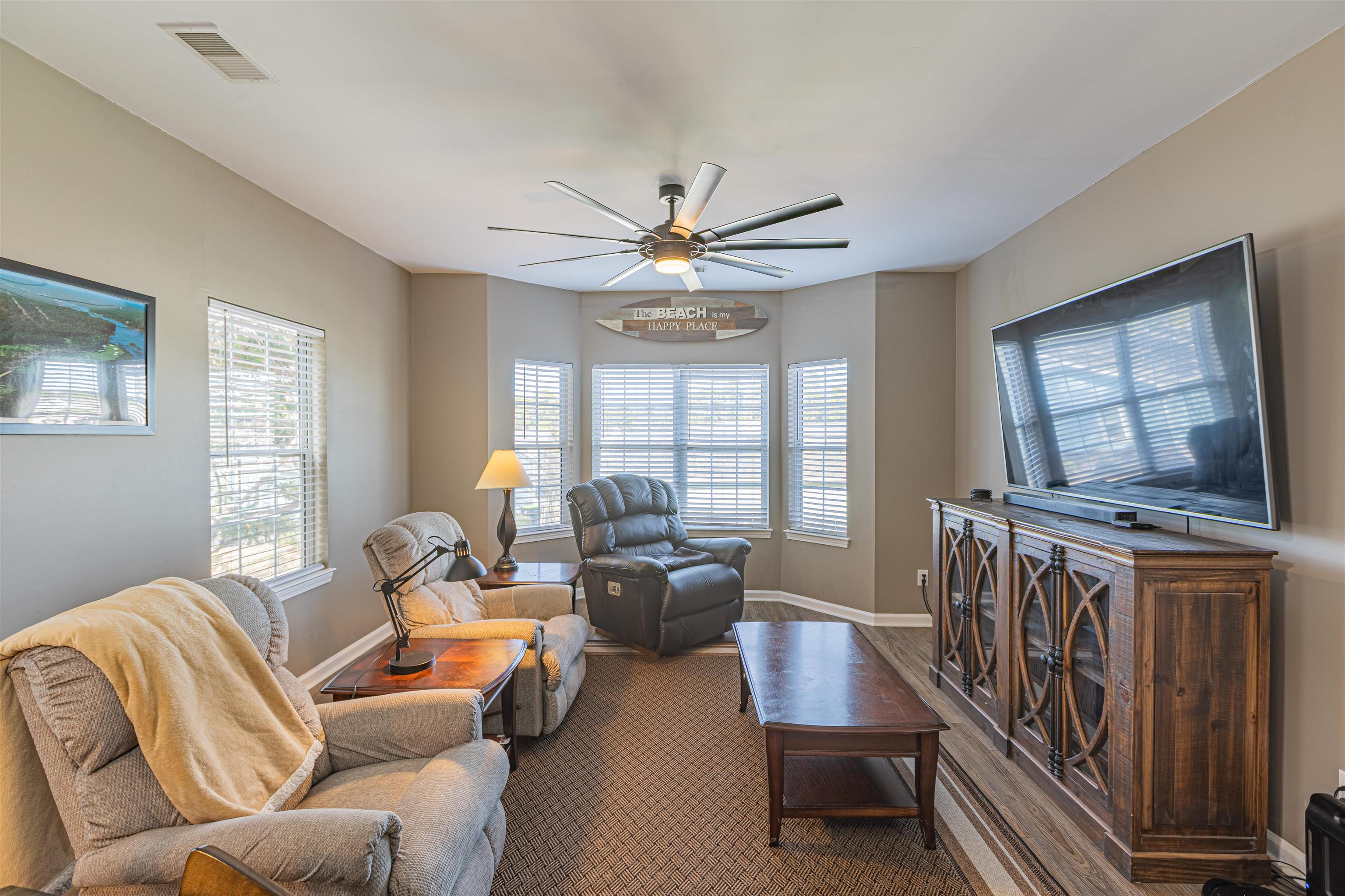 4585 Girvan Drive, Unit D Myrtle Beach, SC 29579 - Photo 5 of 32 Carpeted living area with a ceiling fan and baseboards