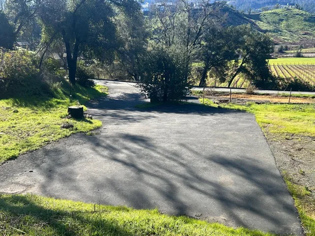a view of a dirt road with trees