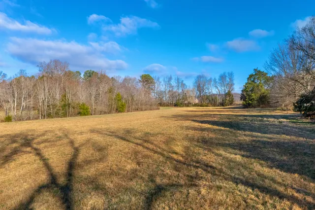 a view of large space with a house in the background