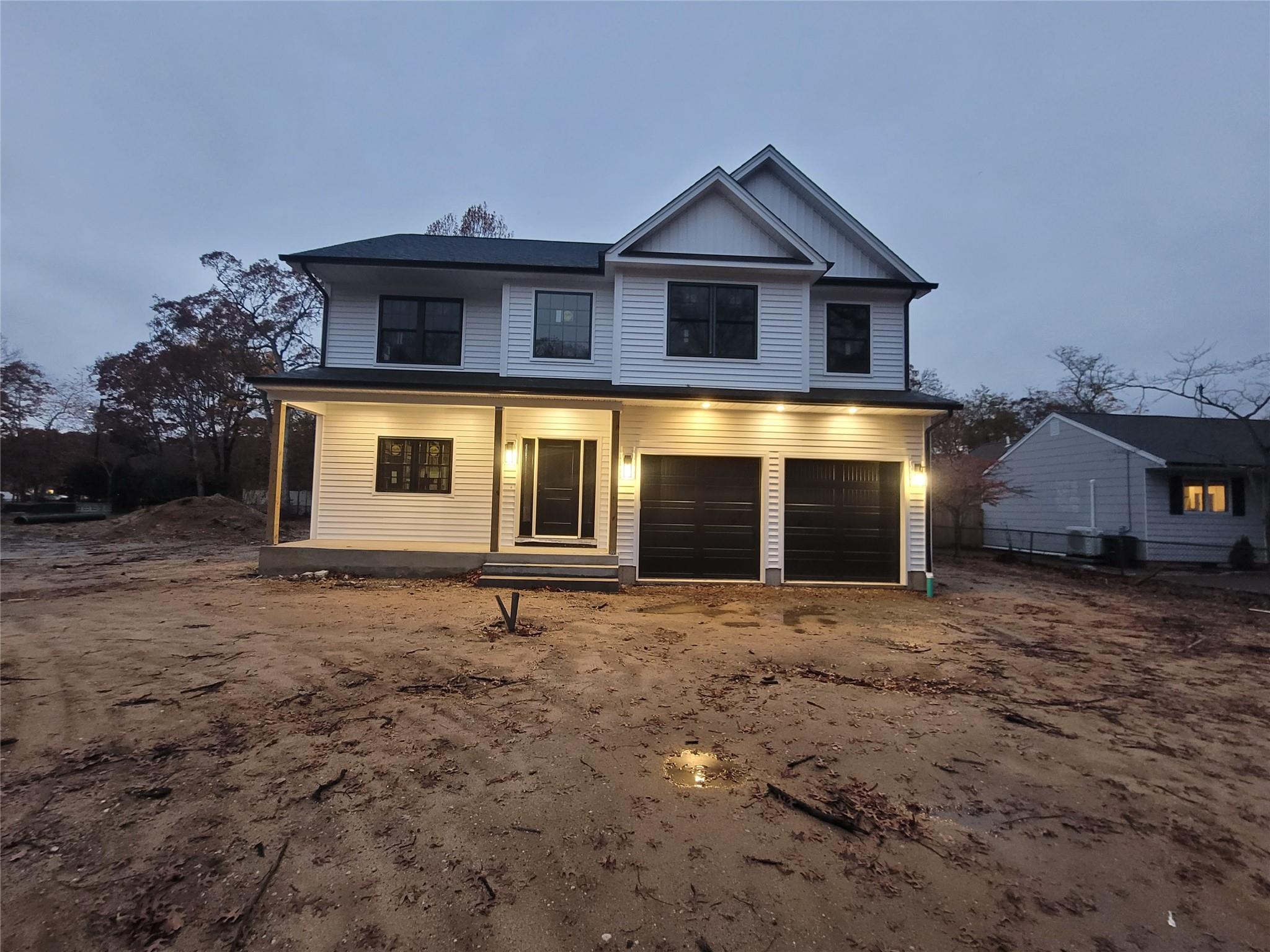 106 Schoolhouse Road East Islip, NY 11730 - Photo 23 of 26 a front view of a house with a yard and garage