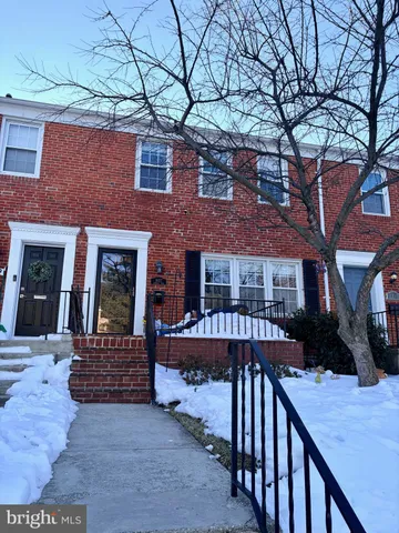 a view of a house with a bench in a patio