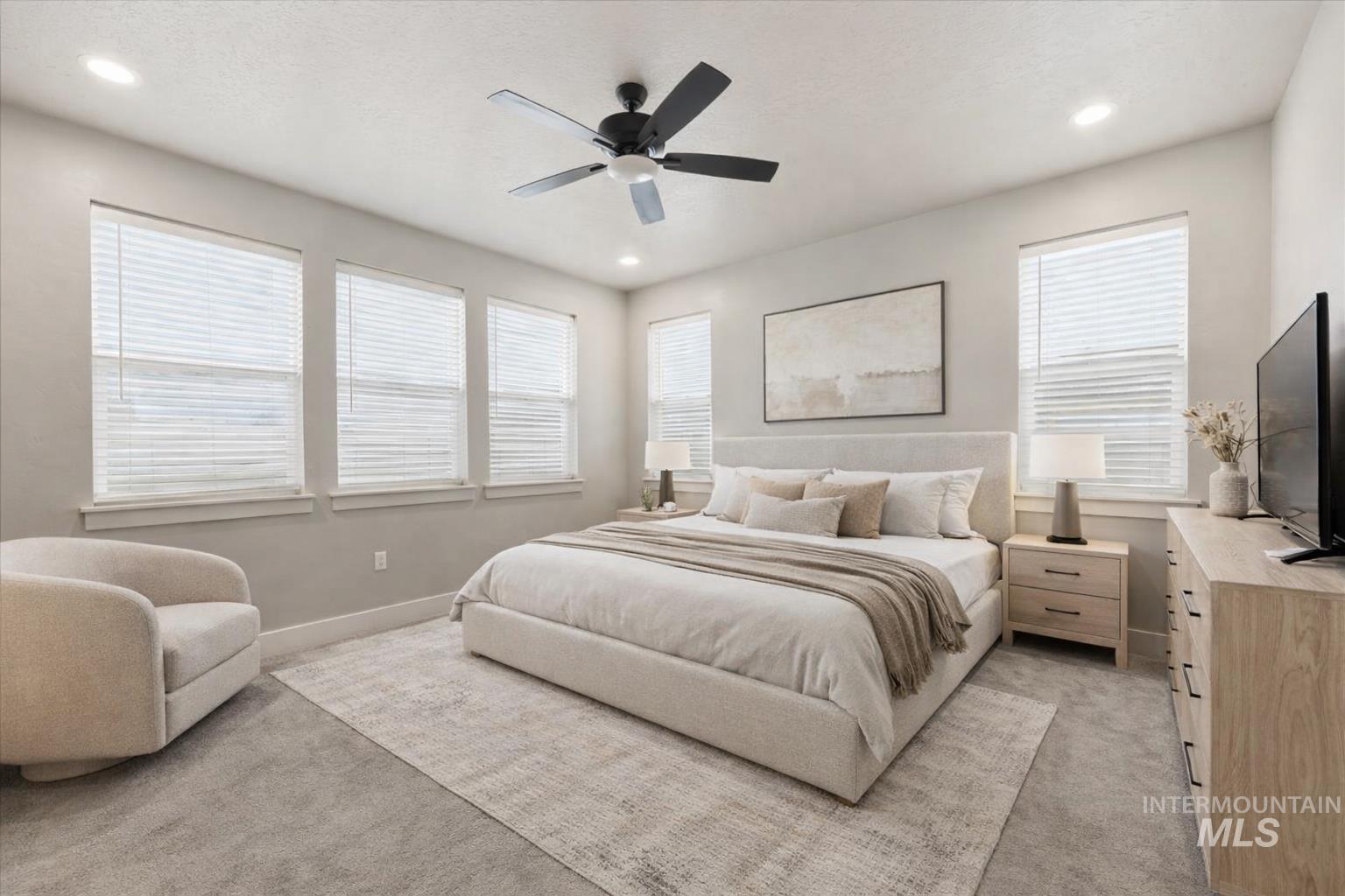 92 South Ravine Way Nampa, ID 83687 - Photo 13 of 29 Bedroom with light carpet, a ceiling fan, multiple windows, and recessed lighting