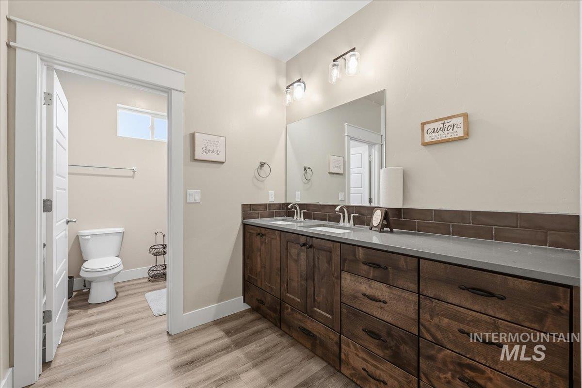 92 South Ravine Way Nampa, ID 83687 - Photo 16 of 29 Full bath with double vanity and light wood-style floors