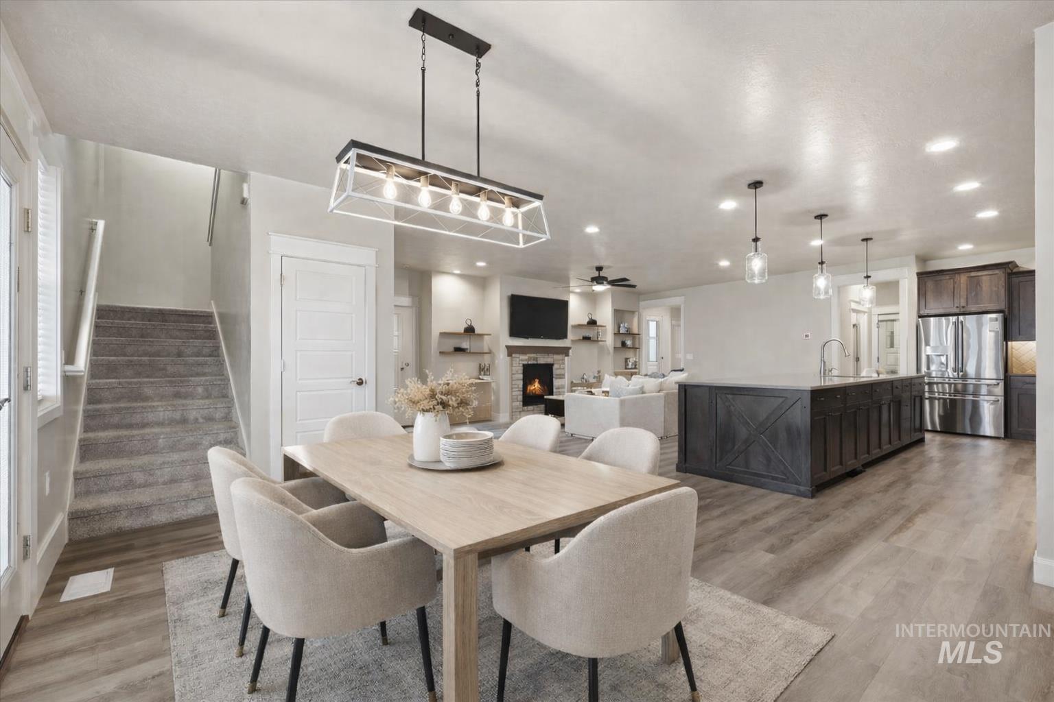 92 South Ravine Way Nampa, ID 83687 - Photo 10 of 29 Dining room with a stone fireplace, light wood-style flooring, ceiling fan, and recessed lighting