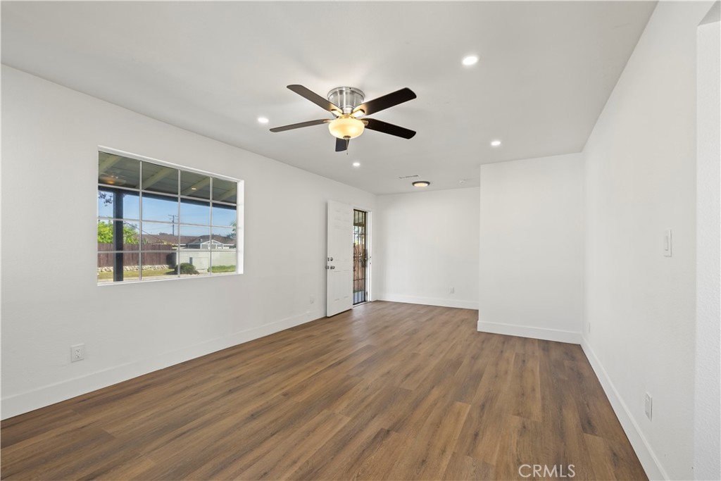 605 West 1st Street Azusa, CA 91702 - Photo 11 of 38 a view of a big room with wooden floor and a ceiling fan
