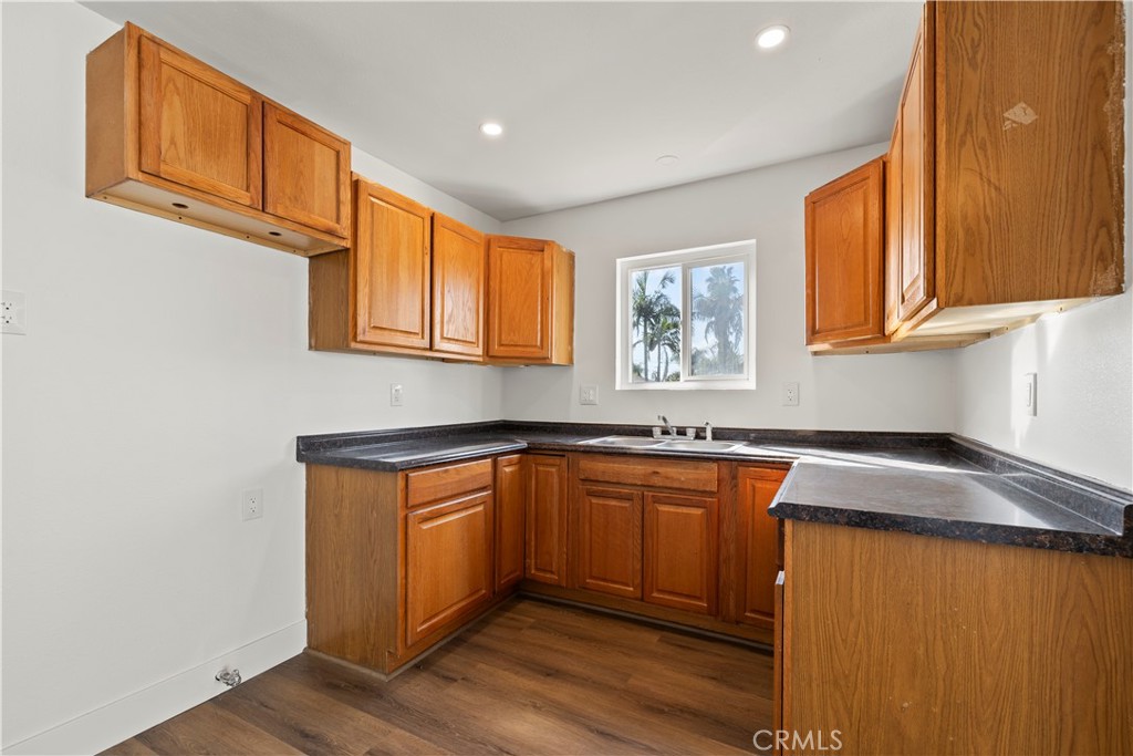 605 West 1st Street Azusa, CA 91702 - Photo 16 of 38 a kitchen with stainless steel appliances granite countertop a sink a stove and a refrigerator