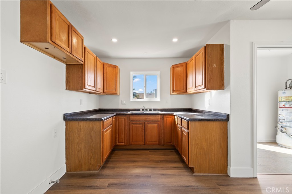 605 West 1st Street Azusa, CA 91702 - Photo 17 of 38 a kitchen with stainless steel appliances granite countertop a sink stove and wooden cabinets