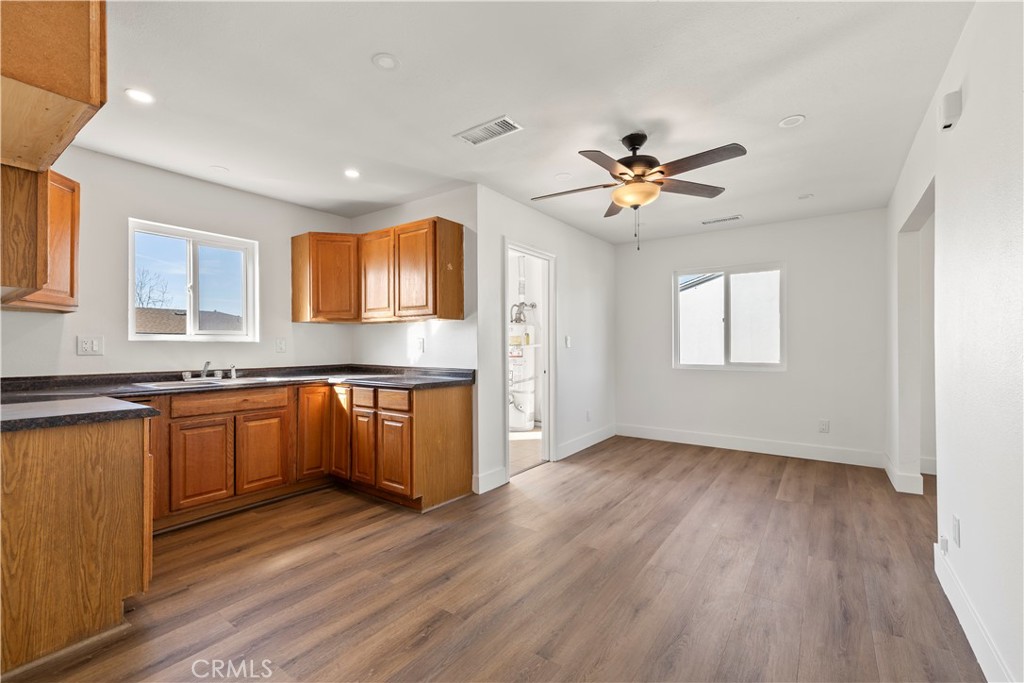 605 West 1st Street Azusa, CA 91702 - Photo 18 of 38 a kitchen with granite countertop a stove a sink wooden floor and a refrigerator with wooden floor