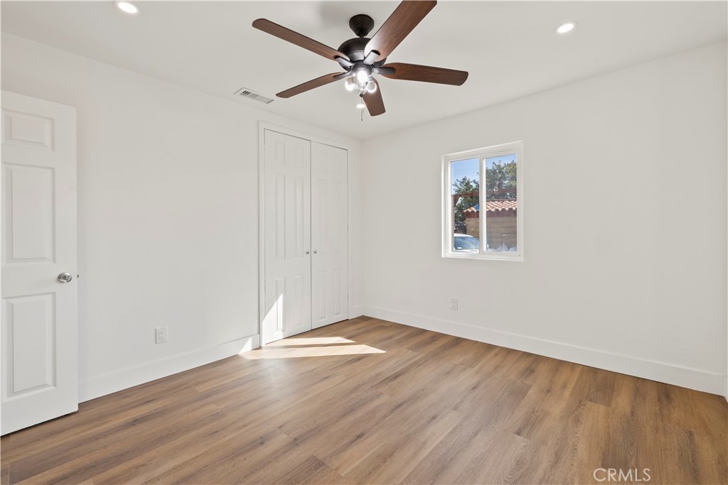 605 West 1st Street Azusa, CA 91702 - Photo 23 of 38 an empty room with wooden floor and windows
