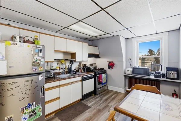 a kitchen with stainless steel appliances a stove a sink and a refrigerator