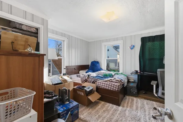 a bedroom with bed and a window