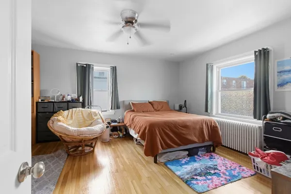 a bedroom with two beds and a chair