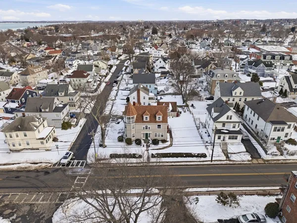 an aerial view of residential houses with city view