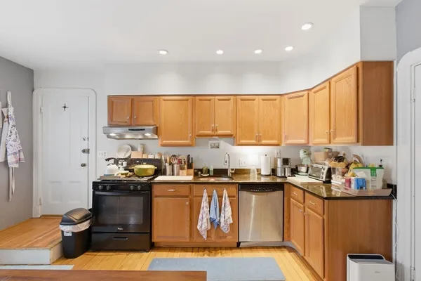 a kitchen with a sink stove and cabinets