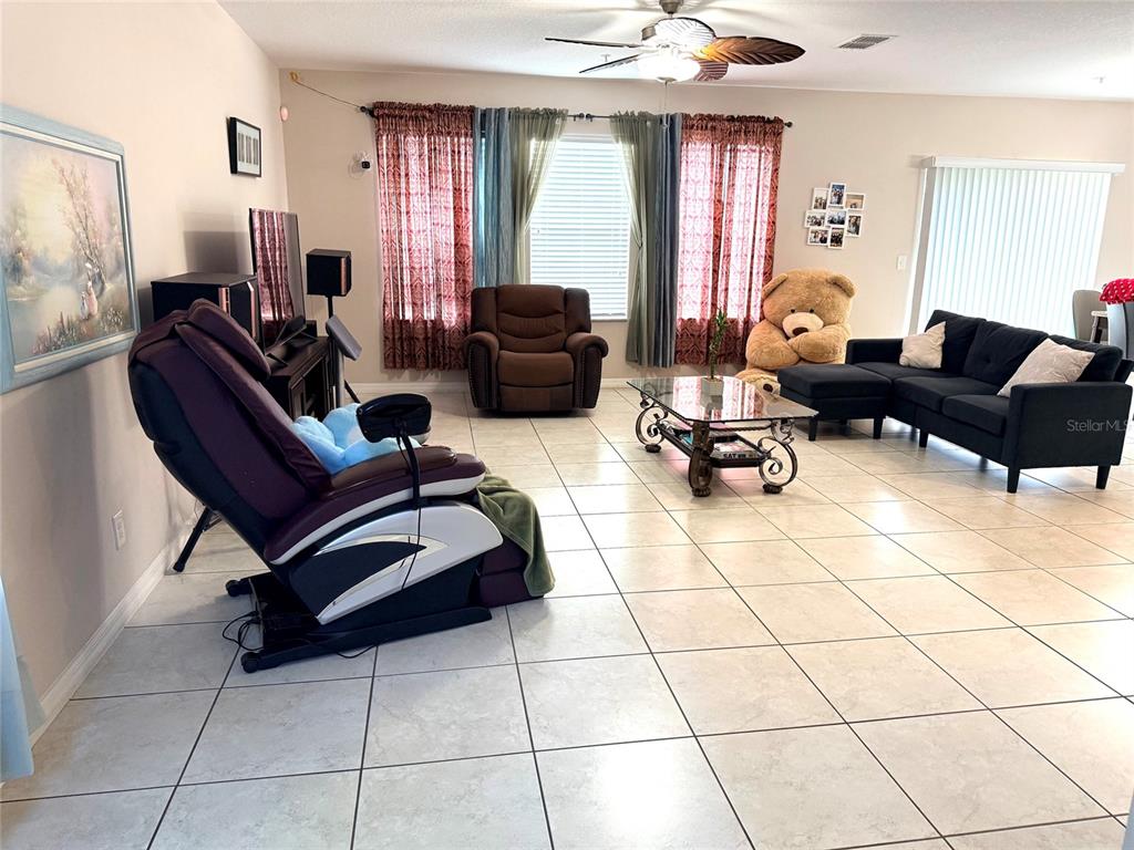 2084 Water Tupelo Way Ocoee, FL 34761 - Photo 3 of 34 a living room with furniture and a large window