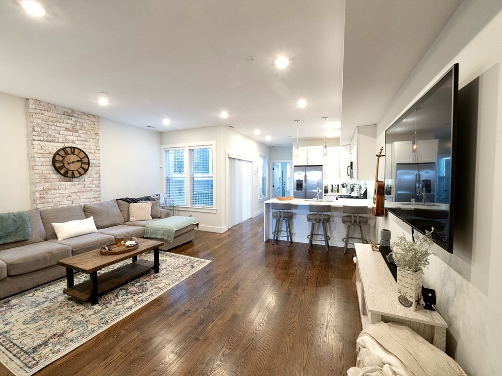 a living room with furniture and kitchen view
