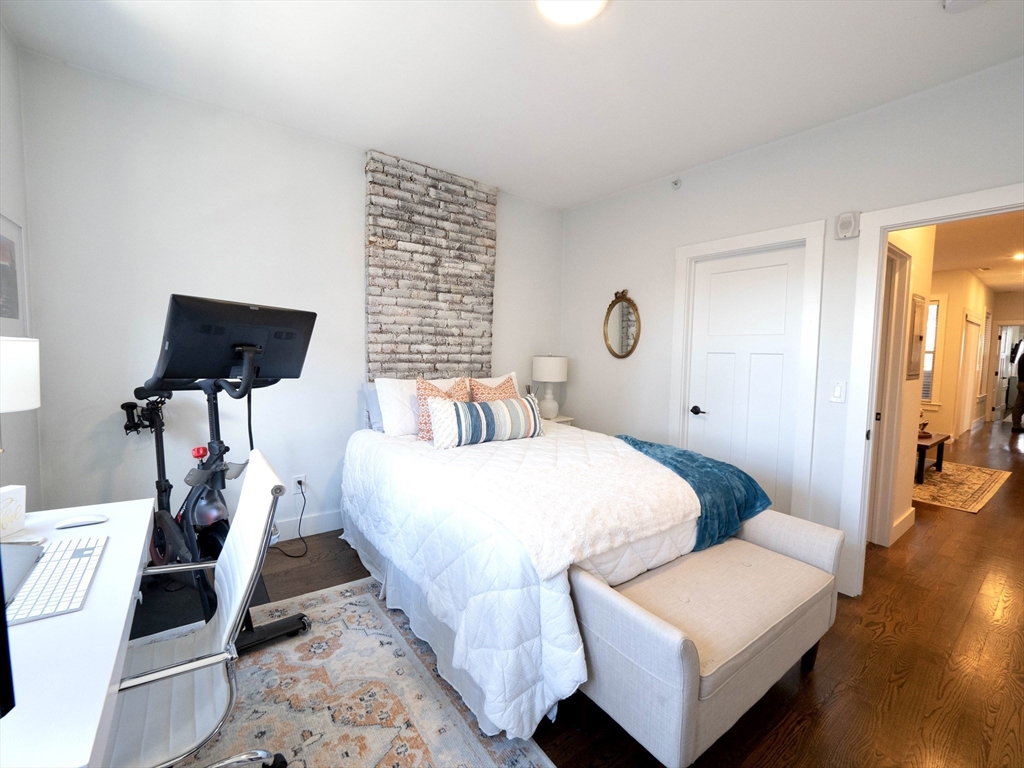 65 Border Street, Unit 4 Boston, MA 02128 - Photo 12 of 15 a bedroom with bed and wooden floor