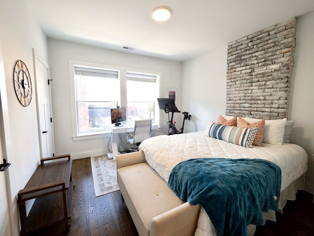 65 Border Street, Unit 4 Boston, MA 02128 - Photo 13 of 15 a bedroom with a bed and wooden floor
