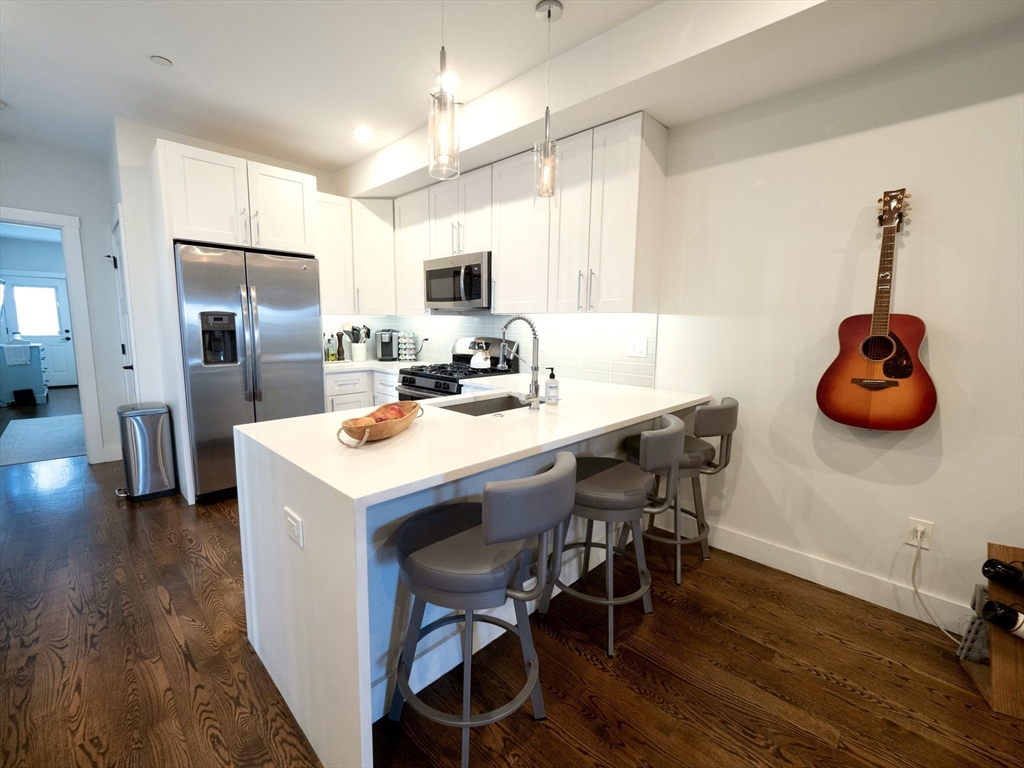 65 Border Street, Unit 4 Boston, MA 02128 - Photo 3 of 15 a kitchen that has a table and chairs in it