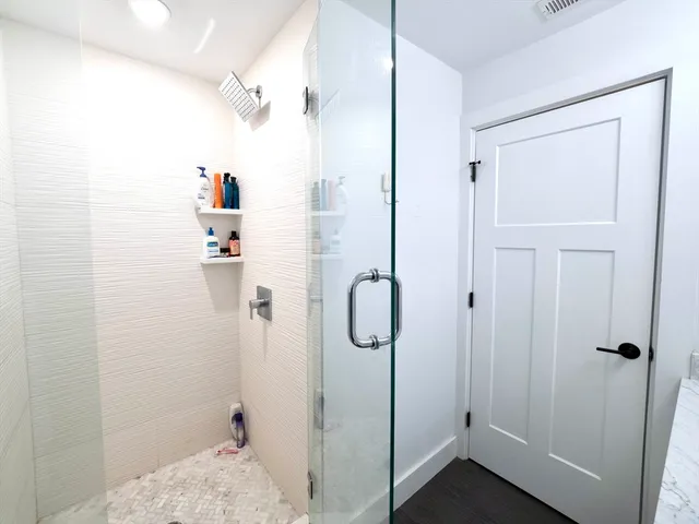 a bathroom with a granite countertop shower