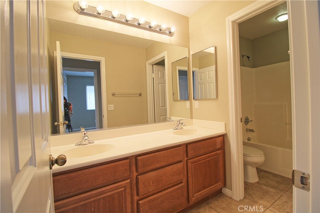 1637 Rigel Street Beaumont, CA 92223 - Photo 19 of 22 a bathroom with a sink and a mirror