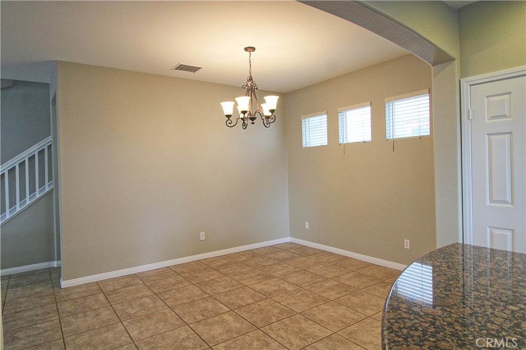 1637 Rigel Street Beaumont, CA 92223 - Photo 9 of 22 a view of a livingroom with a chandelier fan