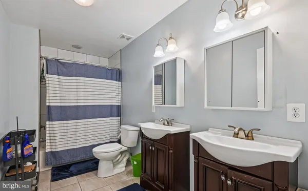 a bathroom with a sink a toilet and mirror