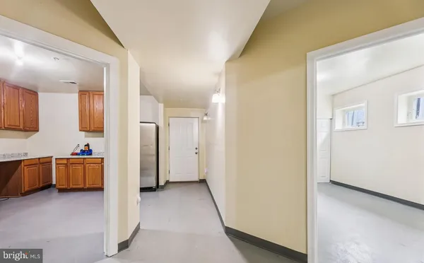 a view of a open shower and a kitchen