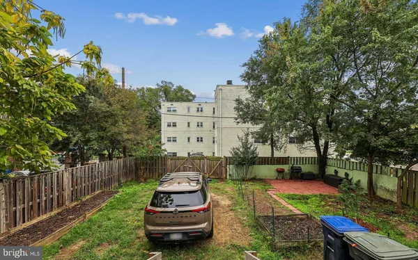 a view of a chairs and table in backyard