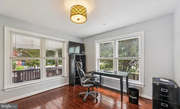 a view of a livingroom with workspace and a window