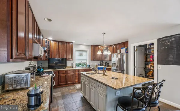 a kitchen with a sink a stove and chairs