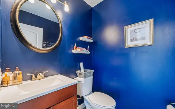 a bathroom with a toilet a sink and mirror