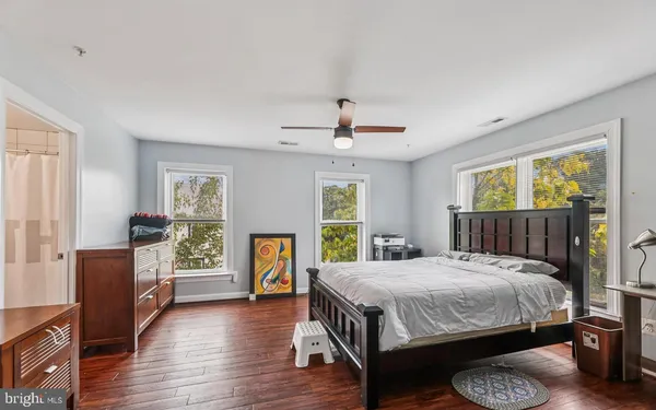 a bedroom with a large bed and a fireplace