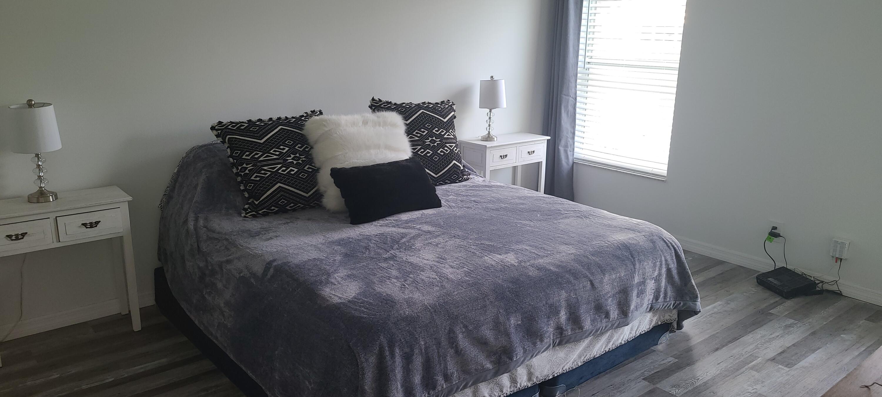 11105 Rios Road Boca Raton, FL 33498 - Photo 17 of 31 a bed sitting in a bedroom next to a window